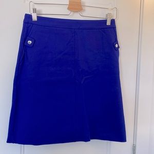Aline double lined electric blue skirt with silver hardware buttons as details.